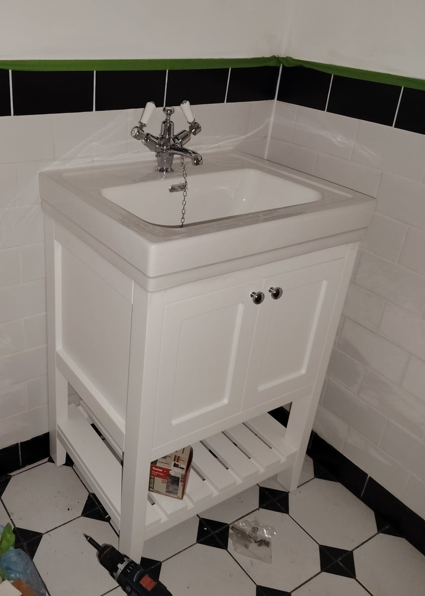 Basin, tap and surrounding tiling during work in progress.