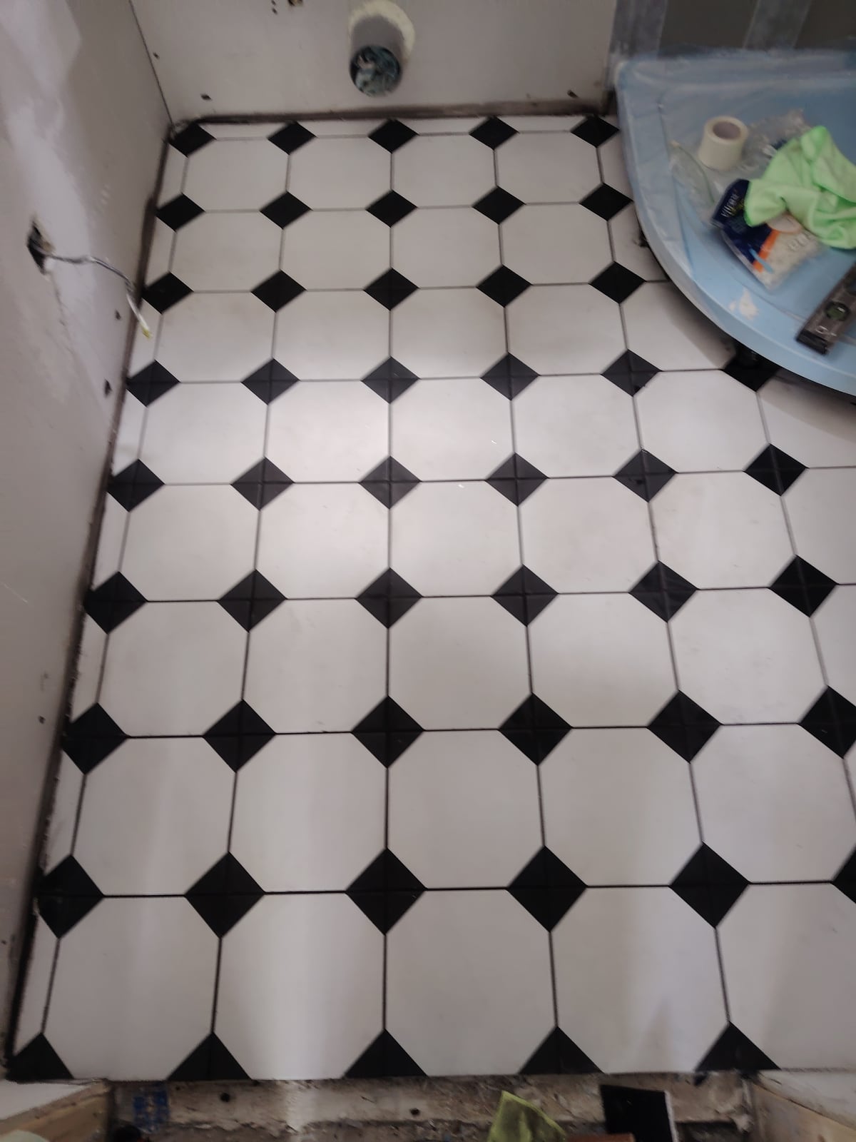 Black-and-white floor tiling during work in progress.