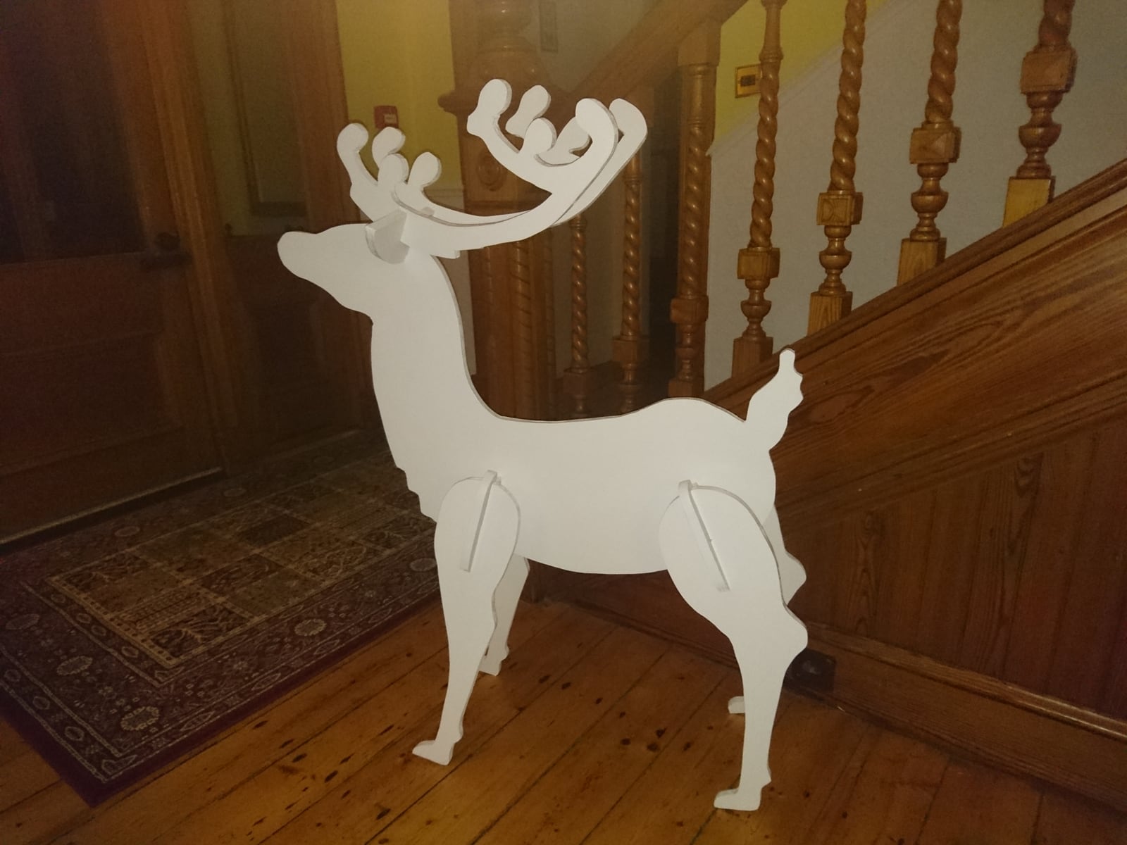 A painted freestanding reindeer decoration.