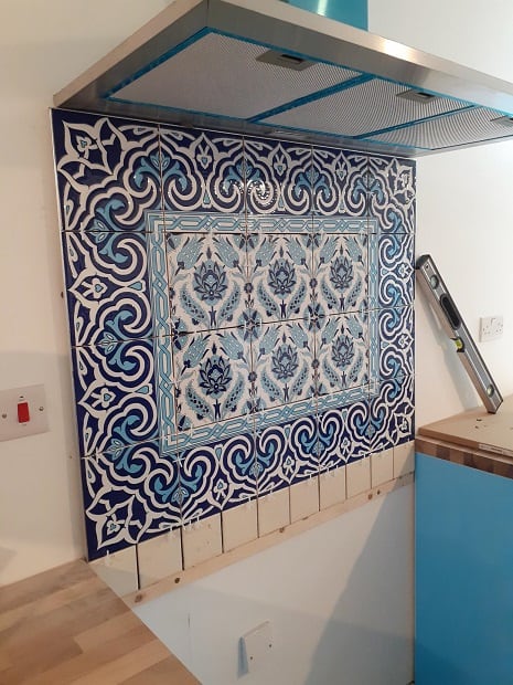 Blue-and-white patterned kitchen tiles during work in progress.